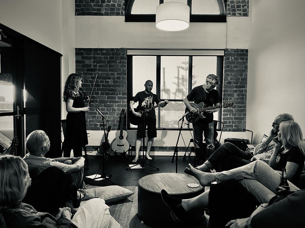 Photo of Rachel, Rob and Dave playing a house concert